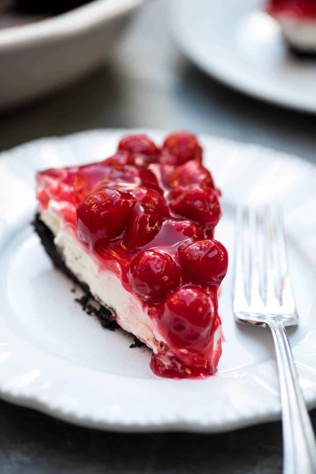 A close up shot of the pie on a white plate with a fork.