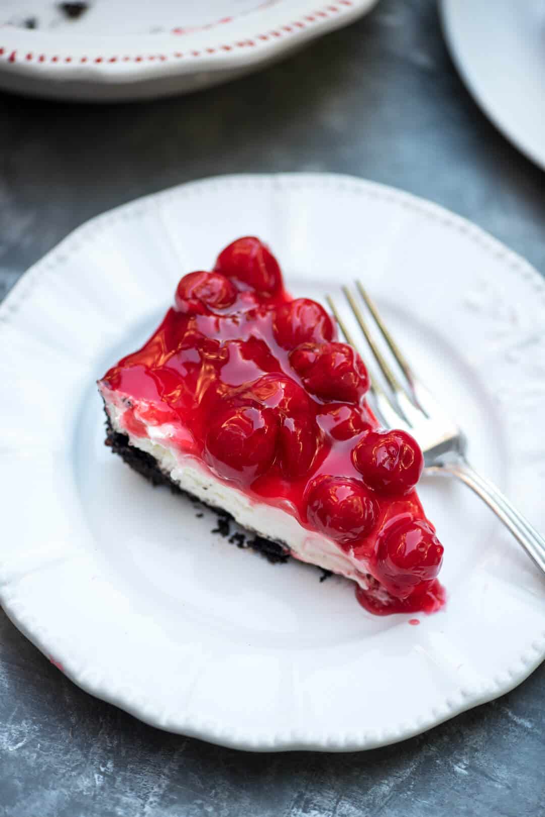 A slice of the pie on a white plate with a fork.