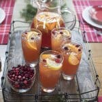 A table topped with festive table settings and a tray of iced tea.