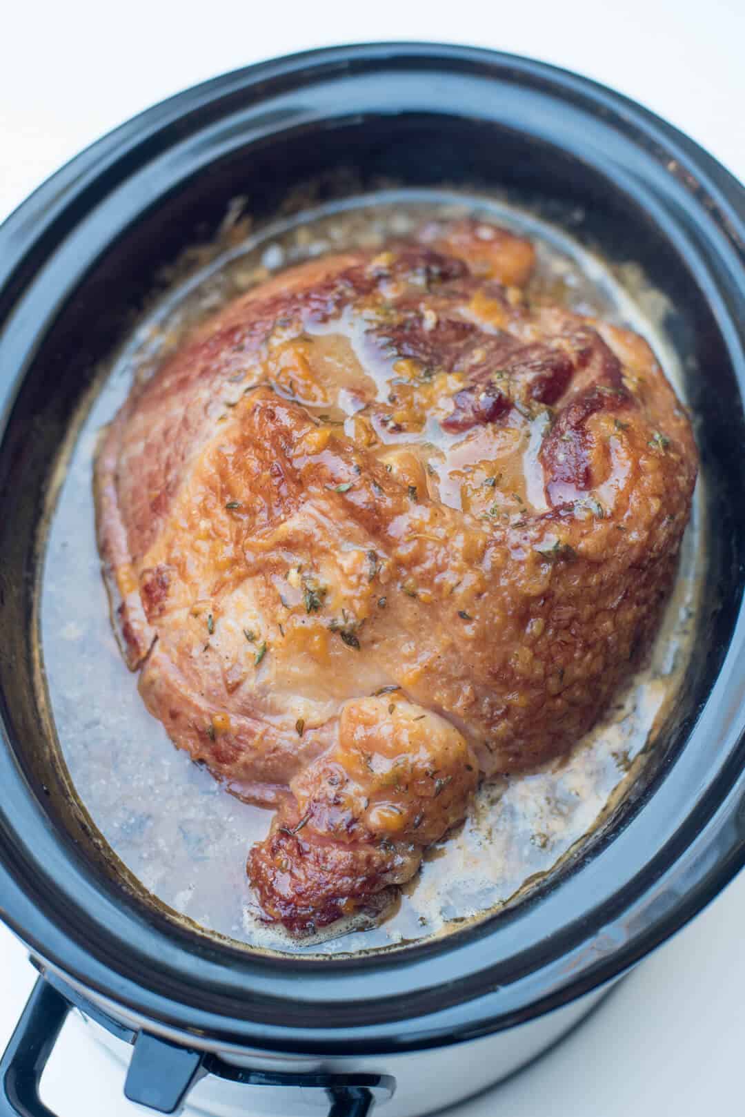 Slow Cooker Ham with Peach Thyme Glaze at the end of the cooking time in the slow cooker.