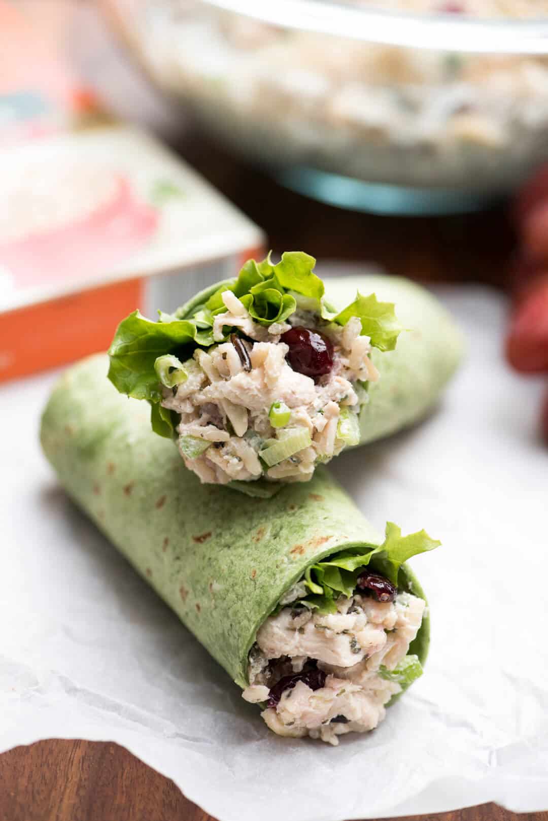 A close up of a chicken salad wrap sliced in half and stacked.