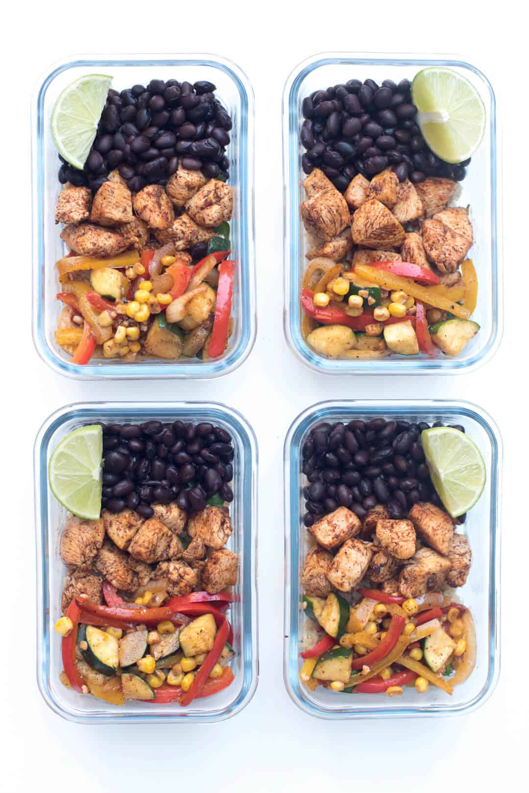 An over the top image of four meal prep containers filled with Tex Mex Chicken.