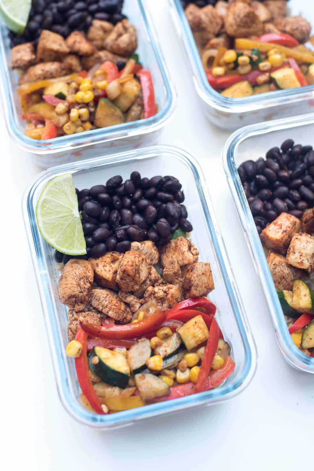 Chicken, peppers, and beans in meal prep containers.