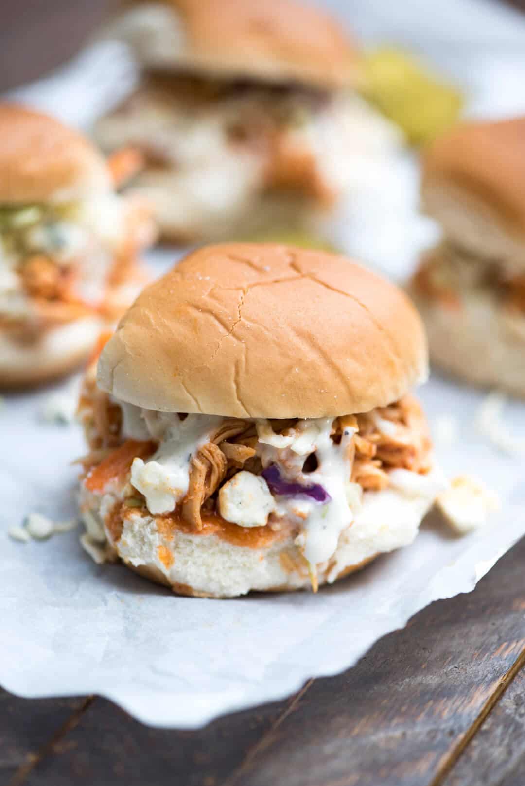 A BBQ Buffalo Chicken Slider with Ranch Dressing and Blue Cheese.