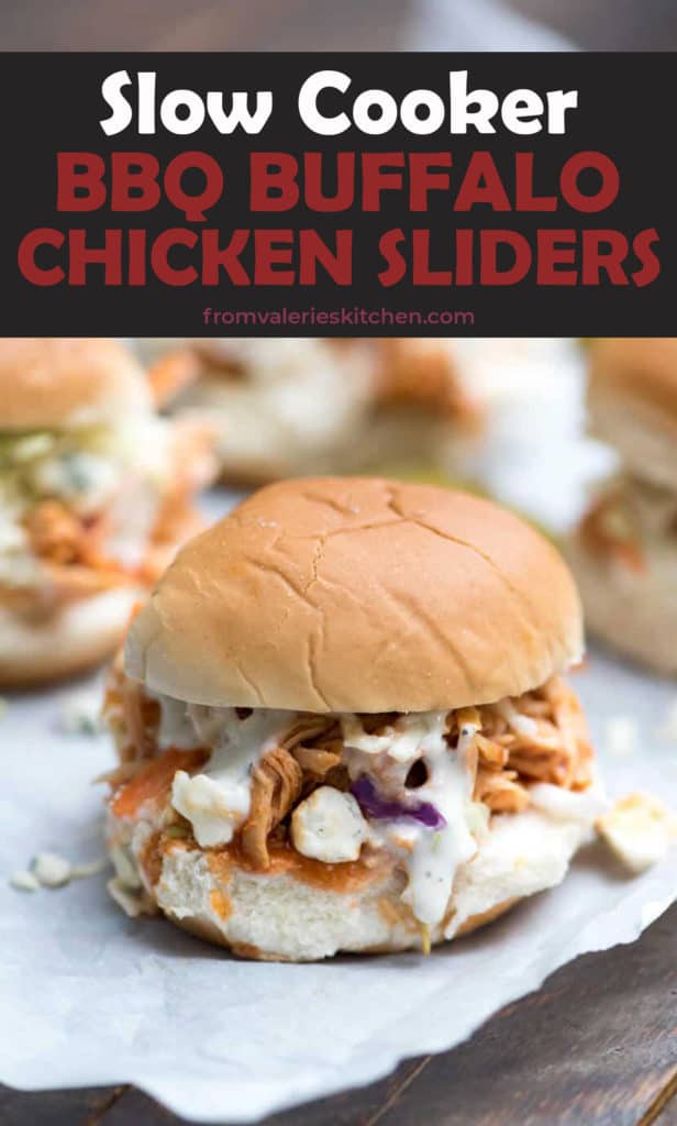 A BBQ Buffalo Chicken Slider with Ranch and blue cheese on parchment paper.