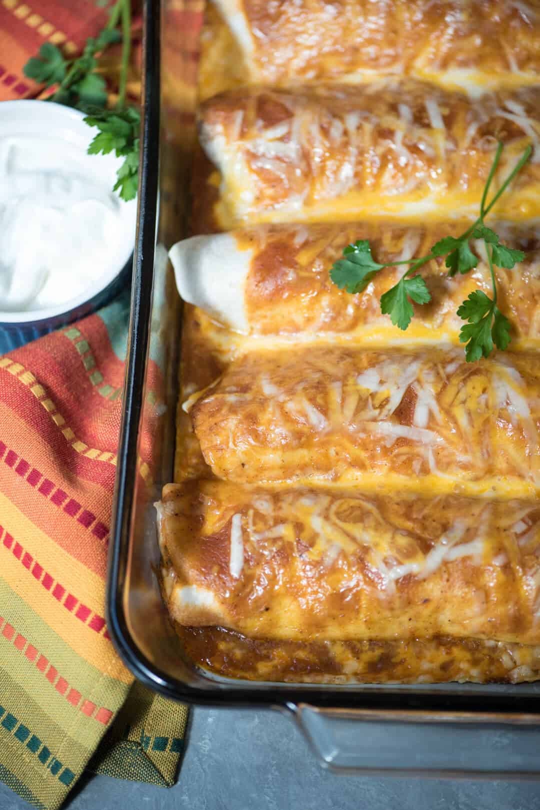 A close up of Turkey Black Bean Enchiladas with melted cheese and cilantro.