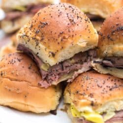 A stack of Italian Roast Beef Sliders stacked on a white plate.