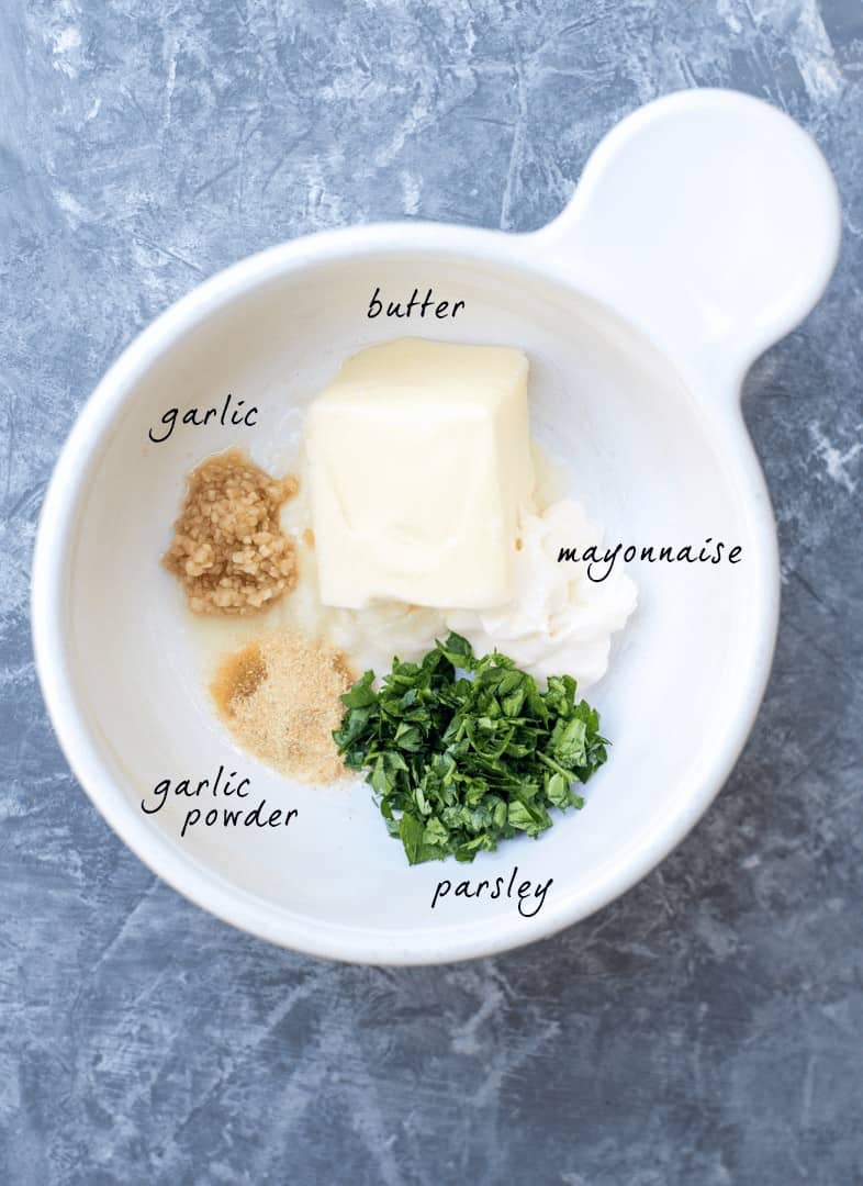 The ingredients for the butter spread in a small white bowl with text overlay.