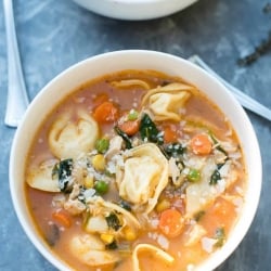 A bowl of Chicken Vegetable Tortellini Soup shot from over the top.