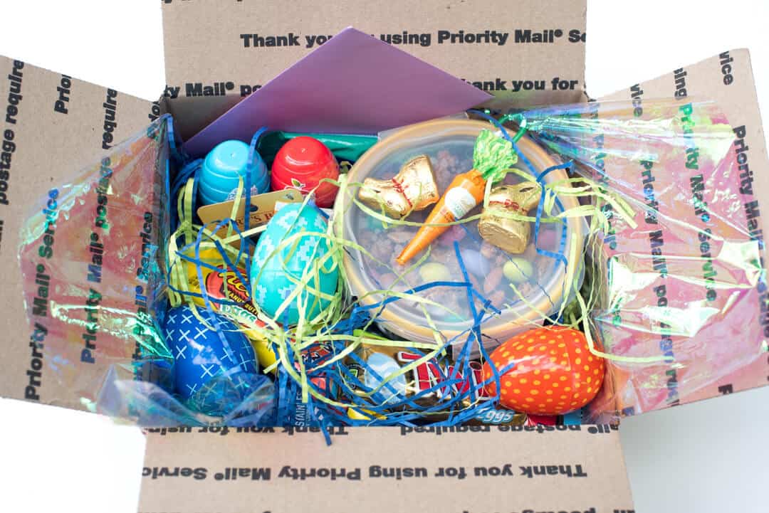 A box packed with Easter care package items.