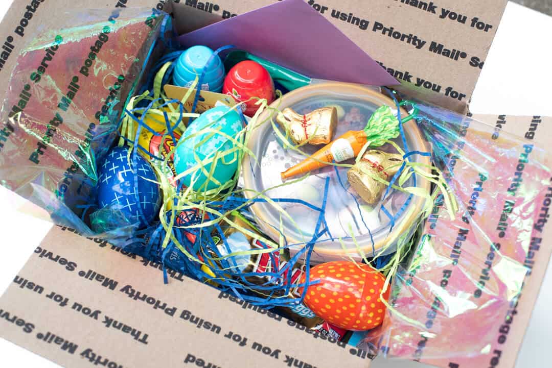 A box packed with Easter candy and other items.