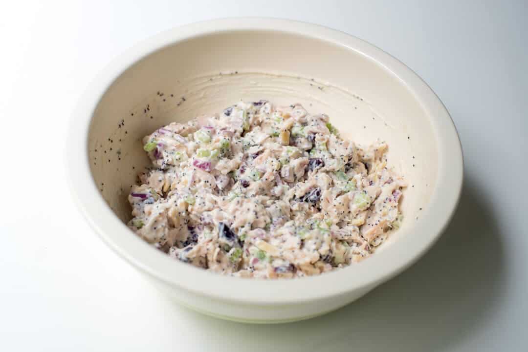 Cranberry Almond Poppy Seed Chicken Salad in a white mixing bowl.