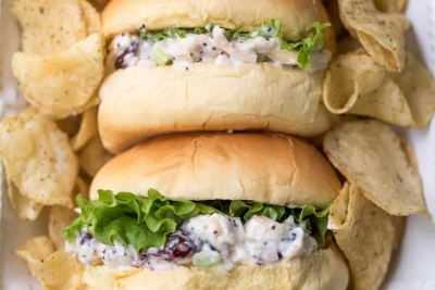 A close up of Cranberry Almond Poppy Seed Chicken Sandwiches on small buns.