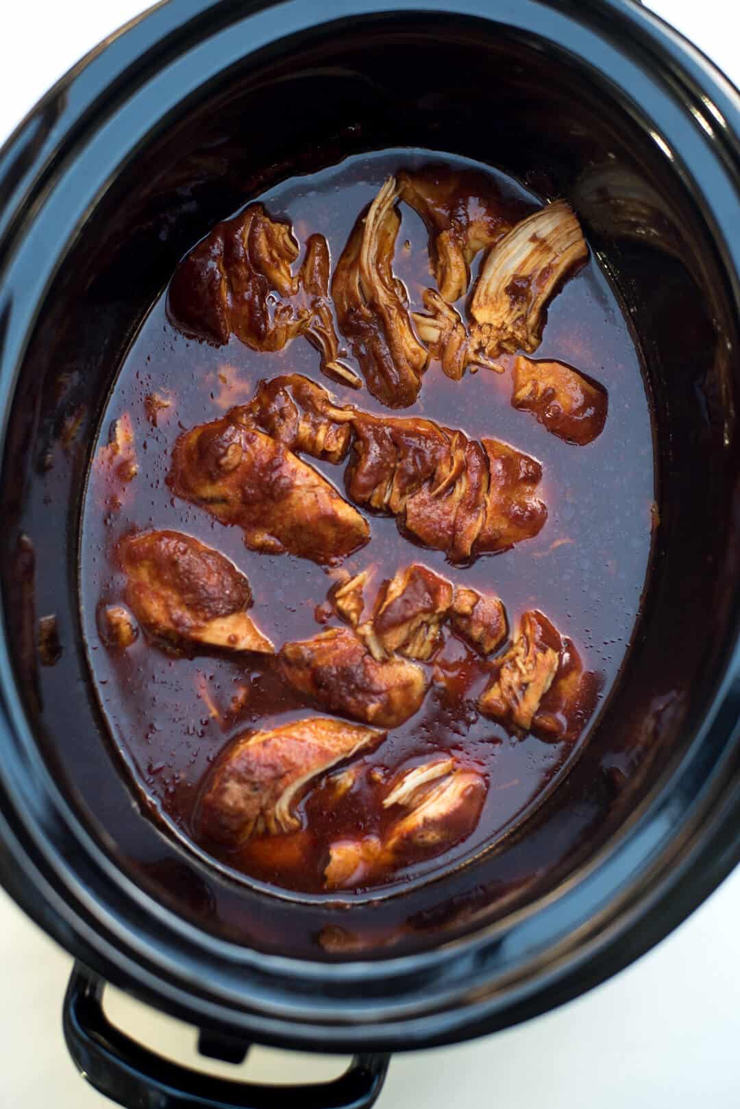 The tender chicken after it has cooked in the slow cooker.