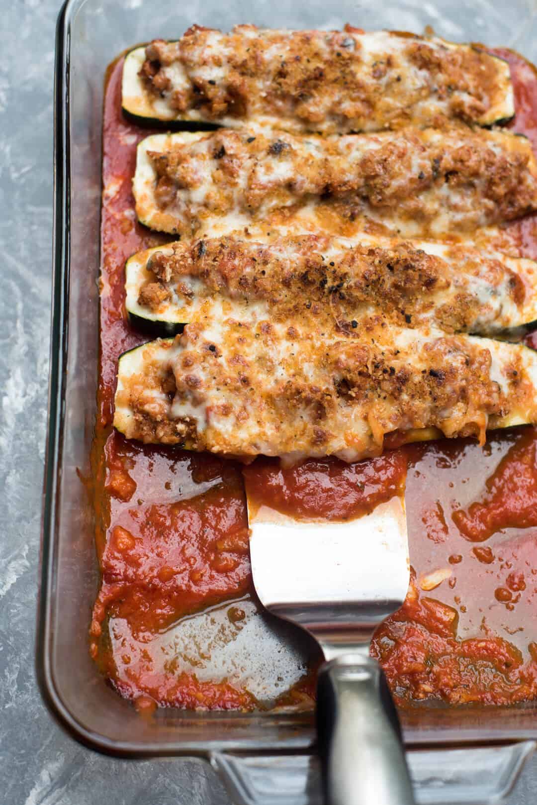 Zucchini boats in a casserole dish.