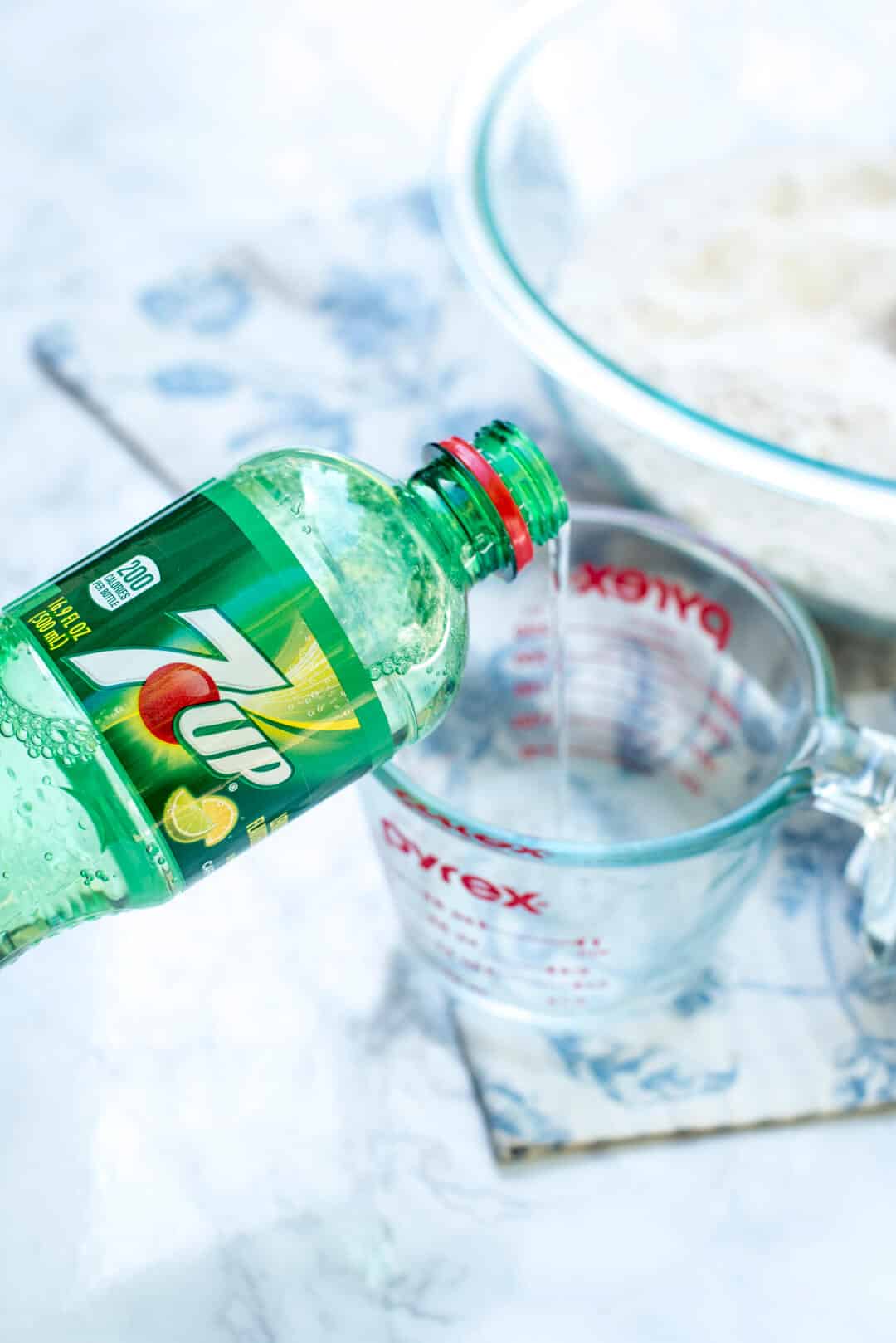 7UP pours from the bottle into a measuring cup.