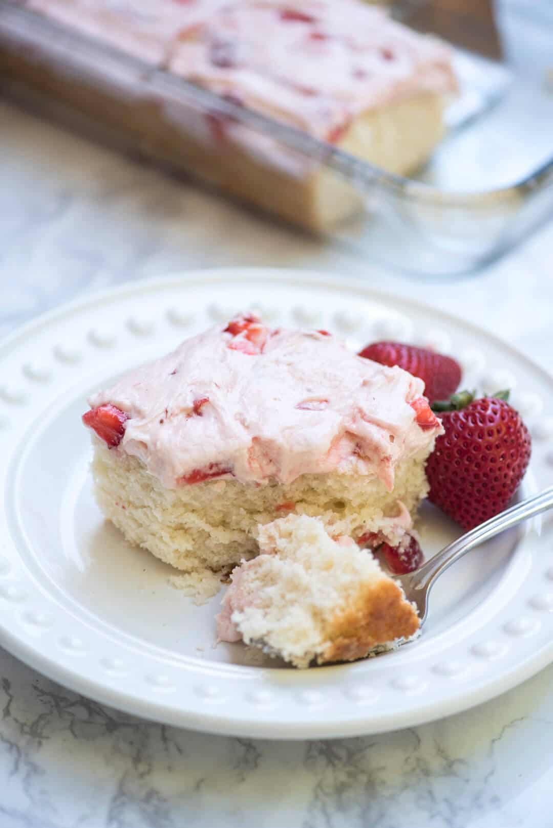 A fork breaks into a slice of 7up cake.