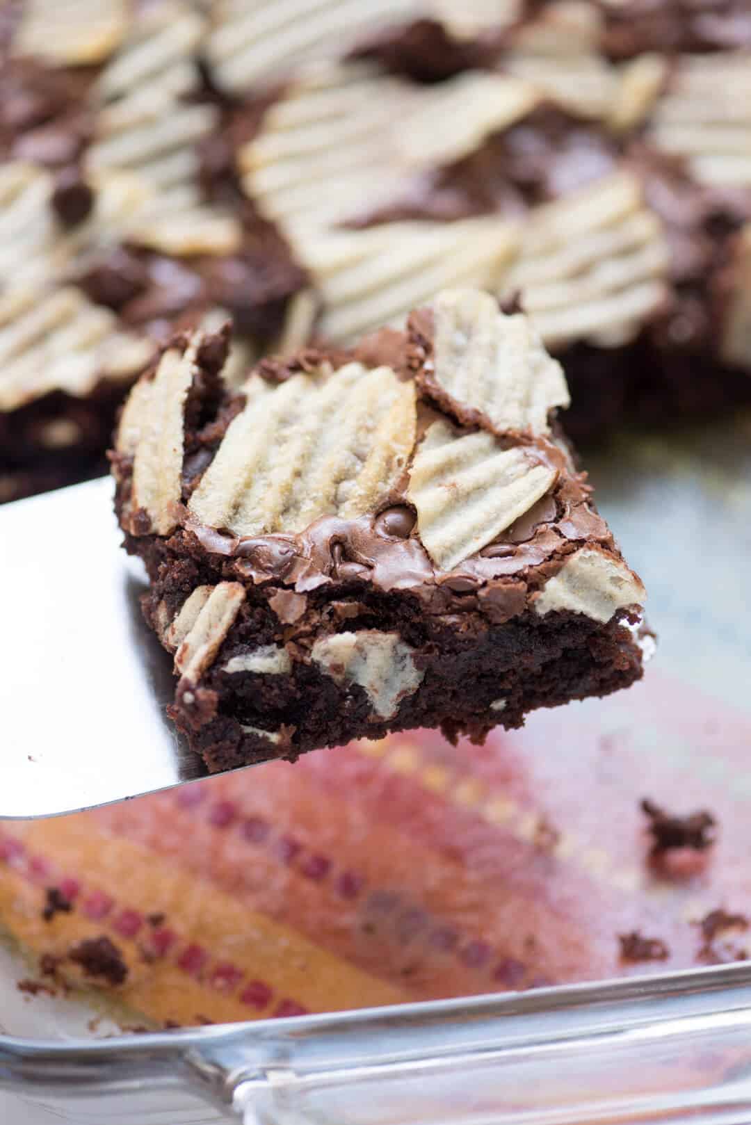 A closeup of a spatula lifting a Potato Chip Brownie.