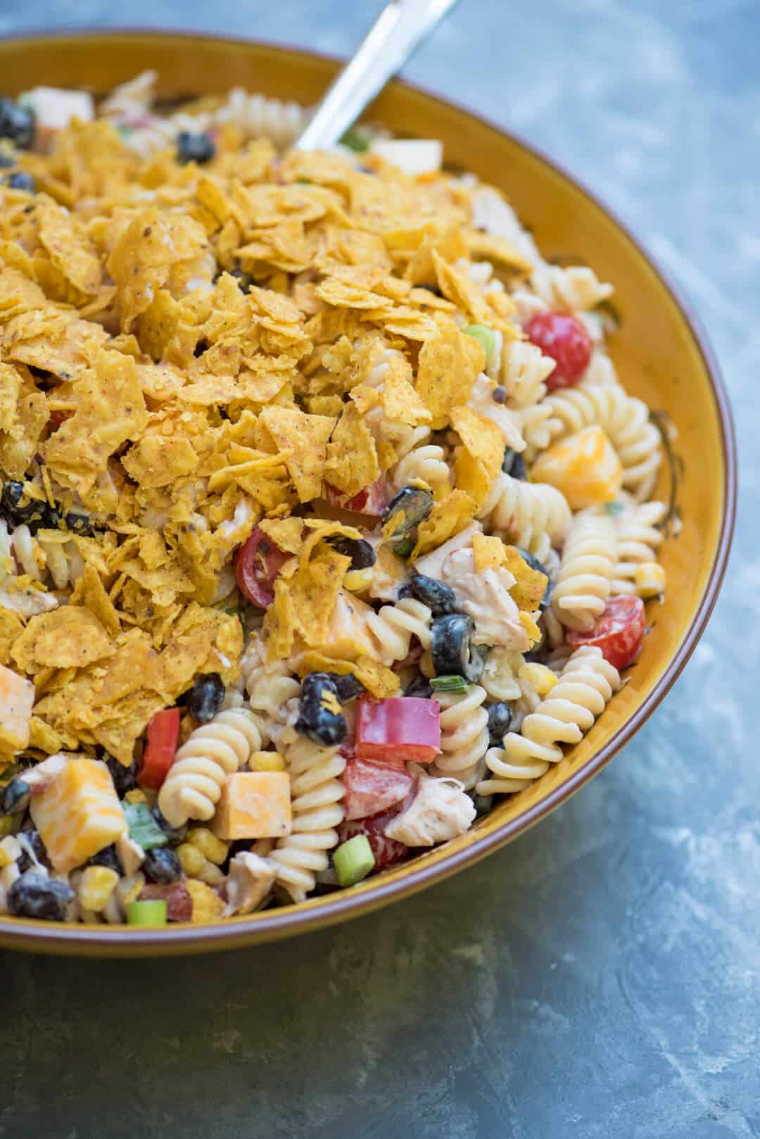 A closeup of the Southwest Ranch Chicken Pasta Salad topped with crushed Doritos.
