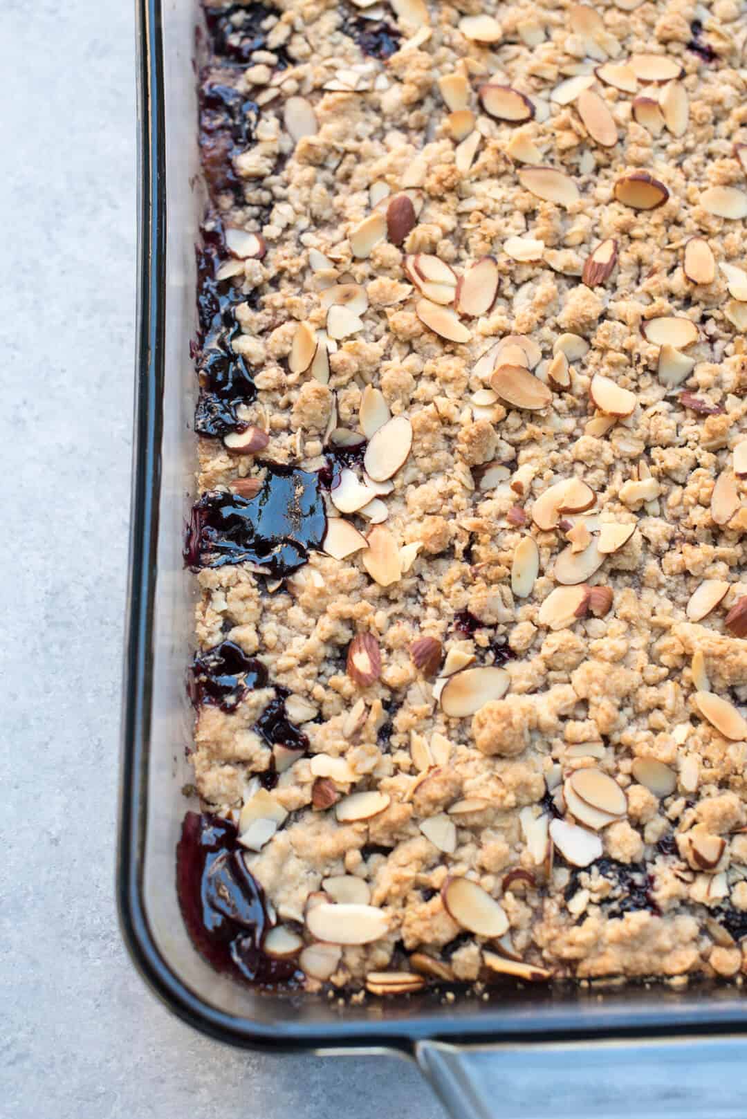 A close up image showing the edges of the baked cherry crisp.