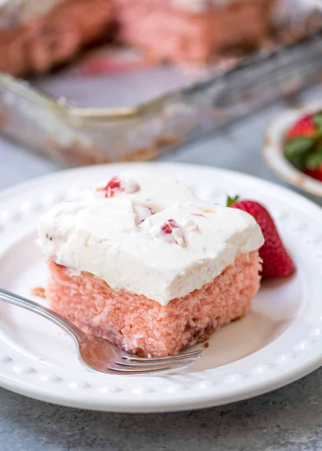 This baked from scratch Strawberry Cake with Strawberry Cream Cheese Frosting has a tender texture and luscious strawberry studded frosting!