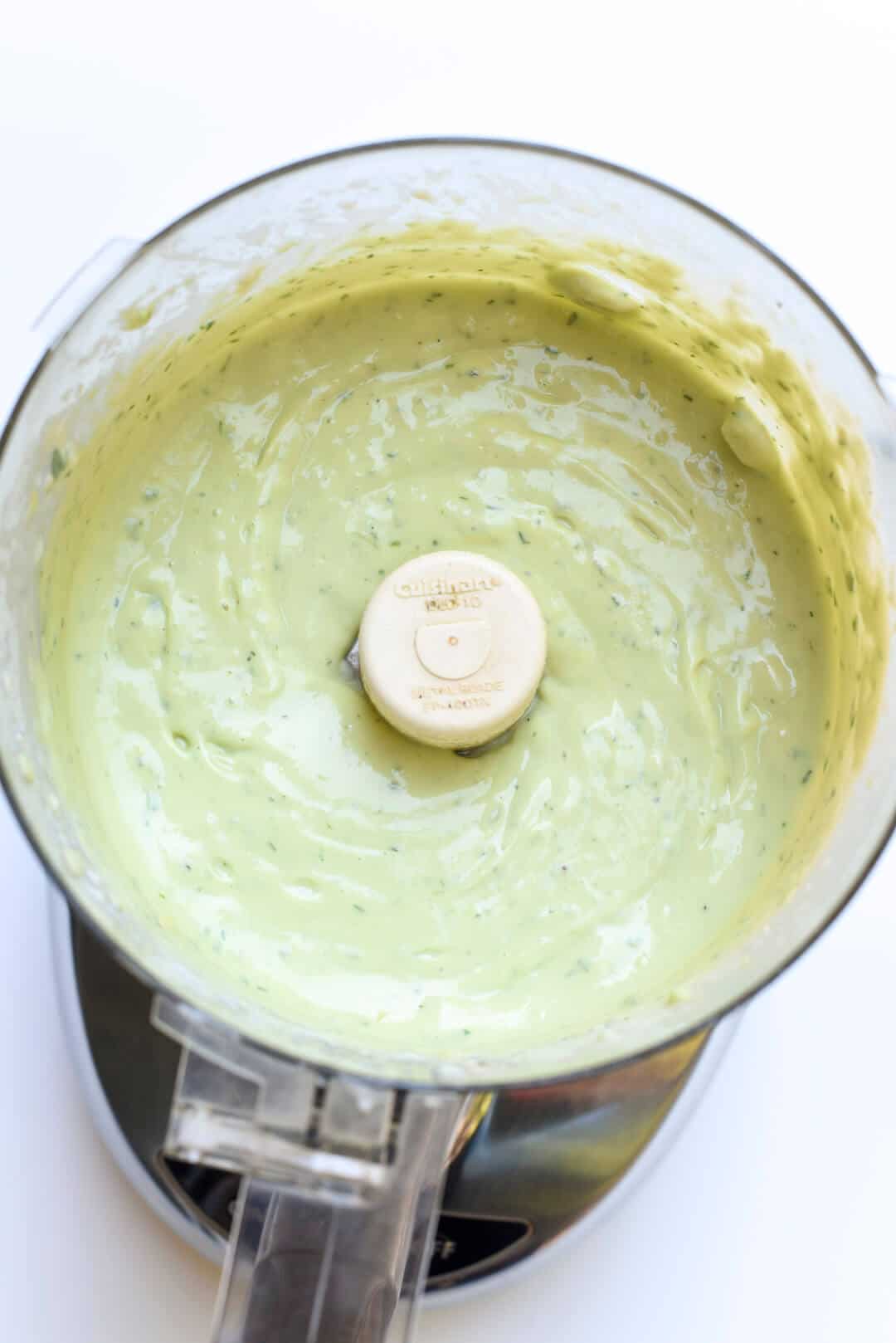 Avocado Ranch Dressing in the bowl of a food processor.
