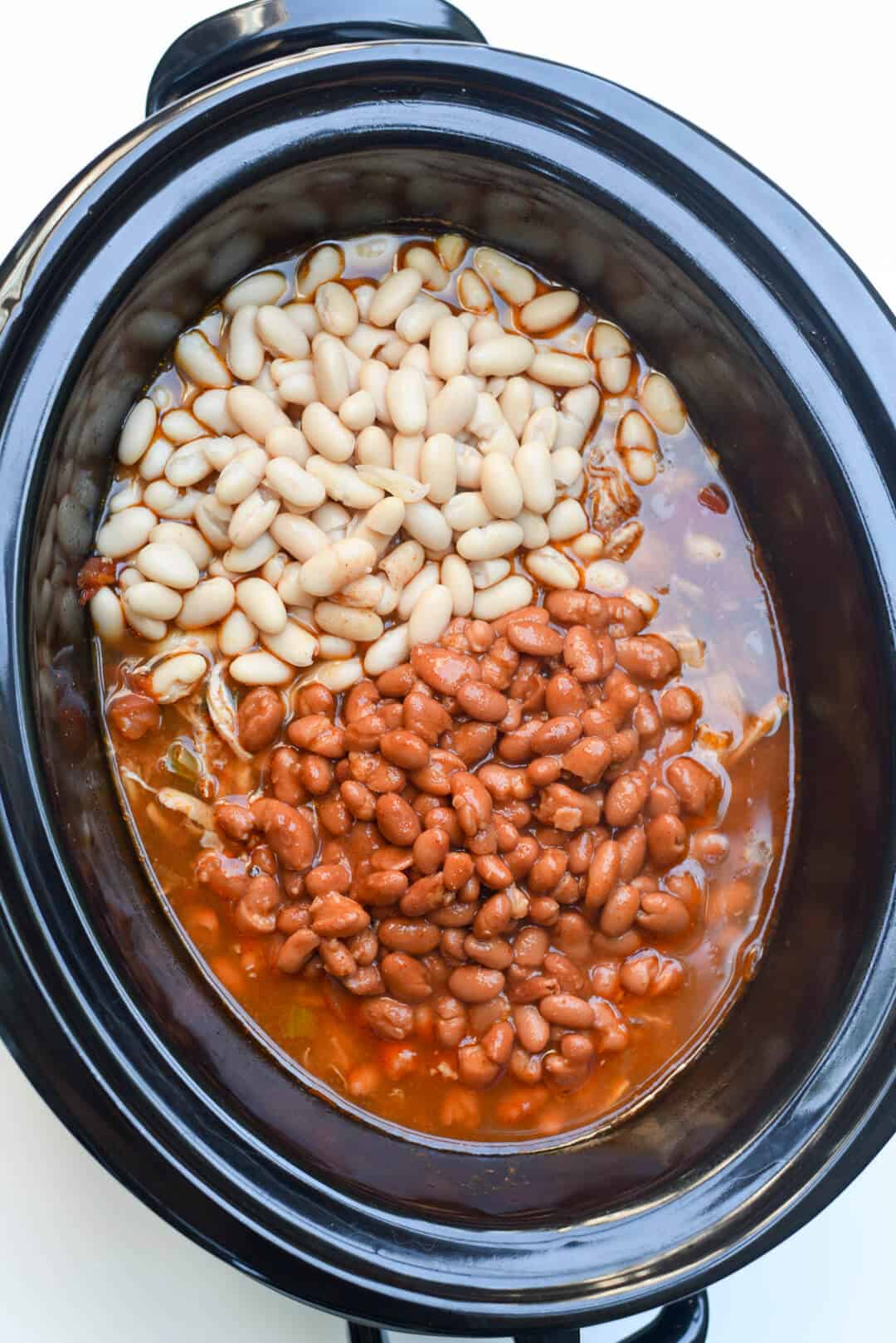 White beans and pinto beans in a slow cooker.