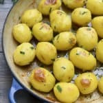 A closeup of browned potatoes in a skillet.