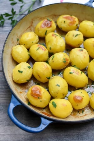 A closeup of browned potatoes in a skillet.