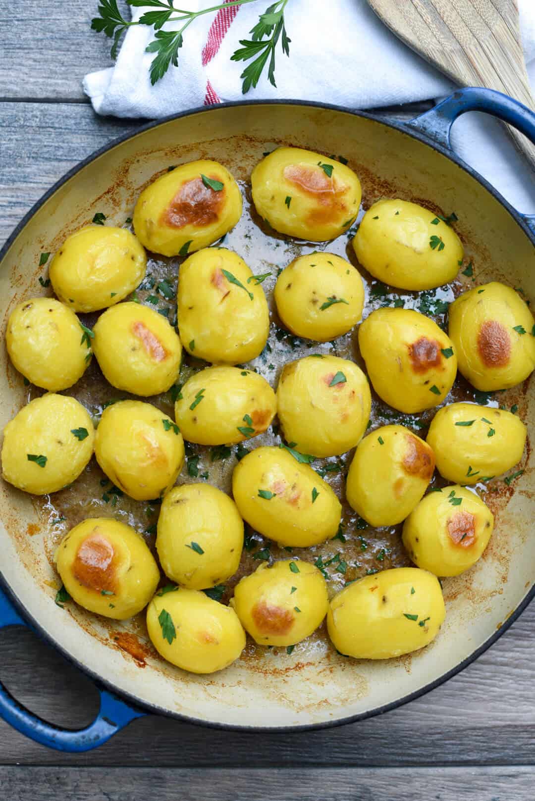 The Garlic and Butter Broth Roasted Potatoes in a skillet shot from over the top.