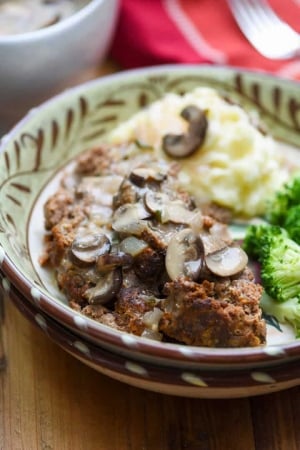 A bowl with meatloaf and sauce.