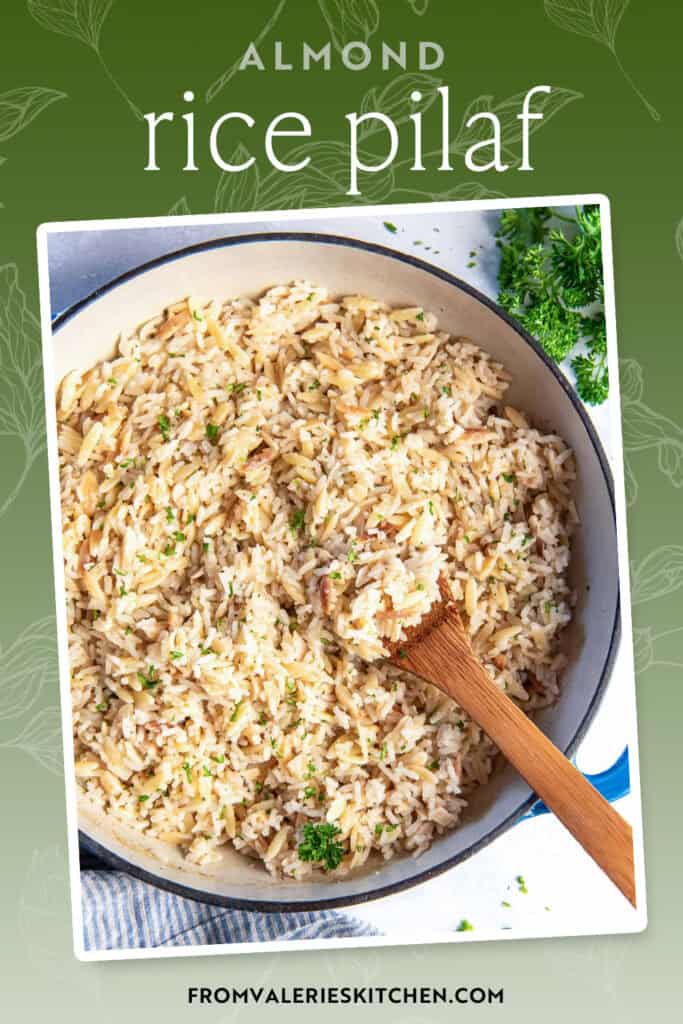 A wooden spoon resting in a pan full of almond rice pilaf with text overlay.