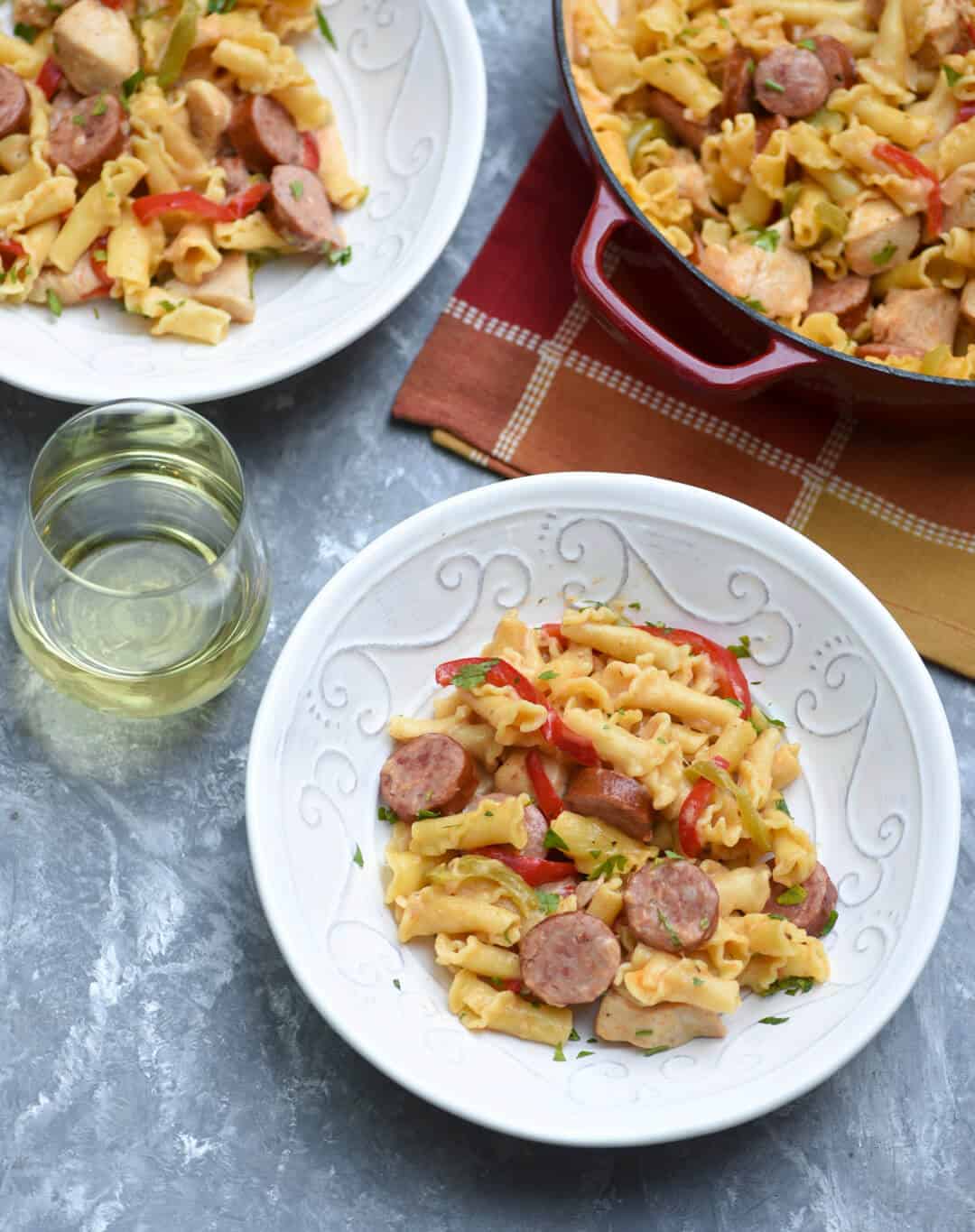 Pasta with sausage in a white bowl.