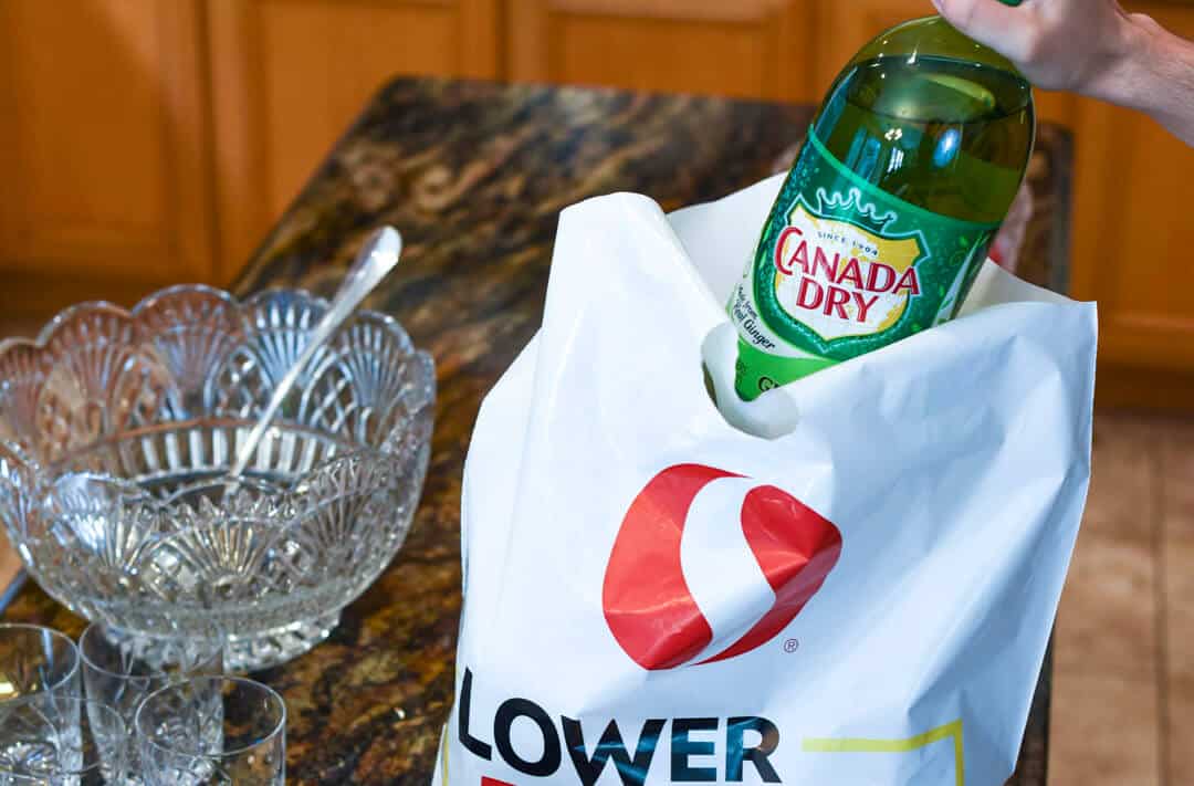 Canada Dry being lifted from a Safeway shopping bag.