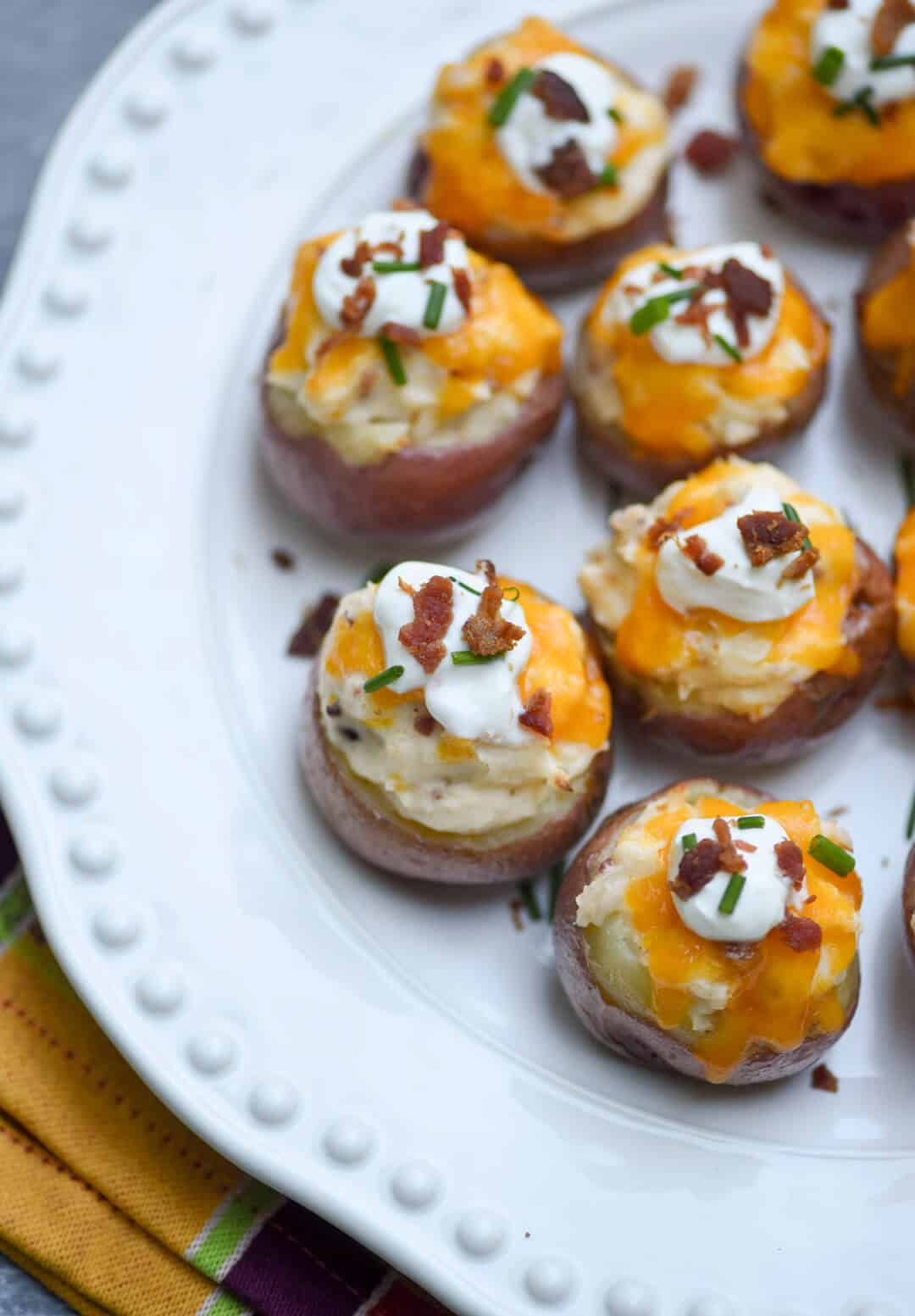 Fully Loaded Twice Baked Potato Bites on a white serving platter.