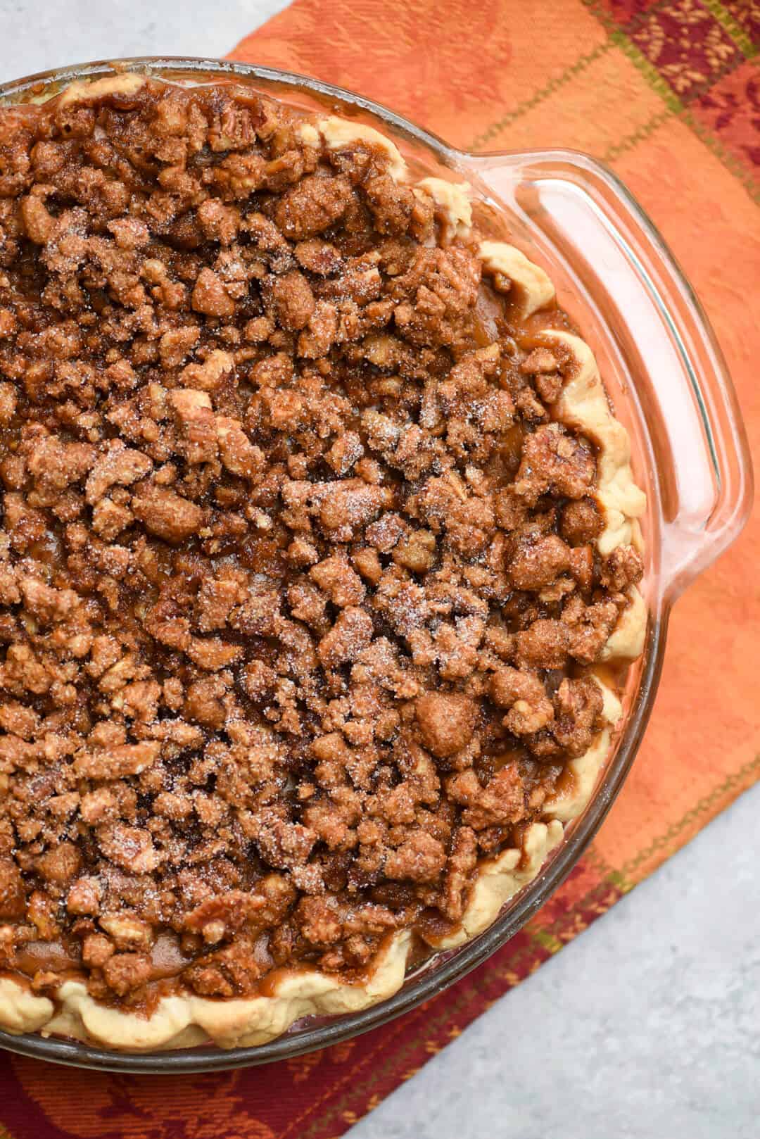 A richly spiced pumpkin pie topped with a sticky sweet pecan praline and baked to perfection. This Praline Pumpkin Pie is a delicious twist on the classic!