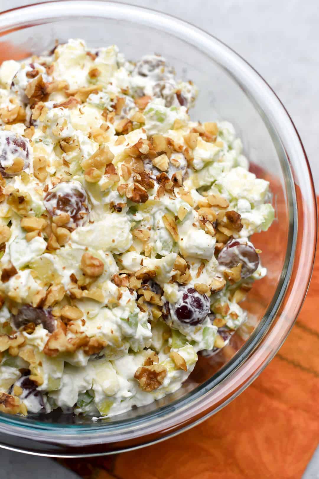 A large serving bowl full of Waldorf Salad shot from over the top.