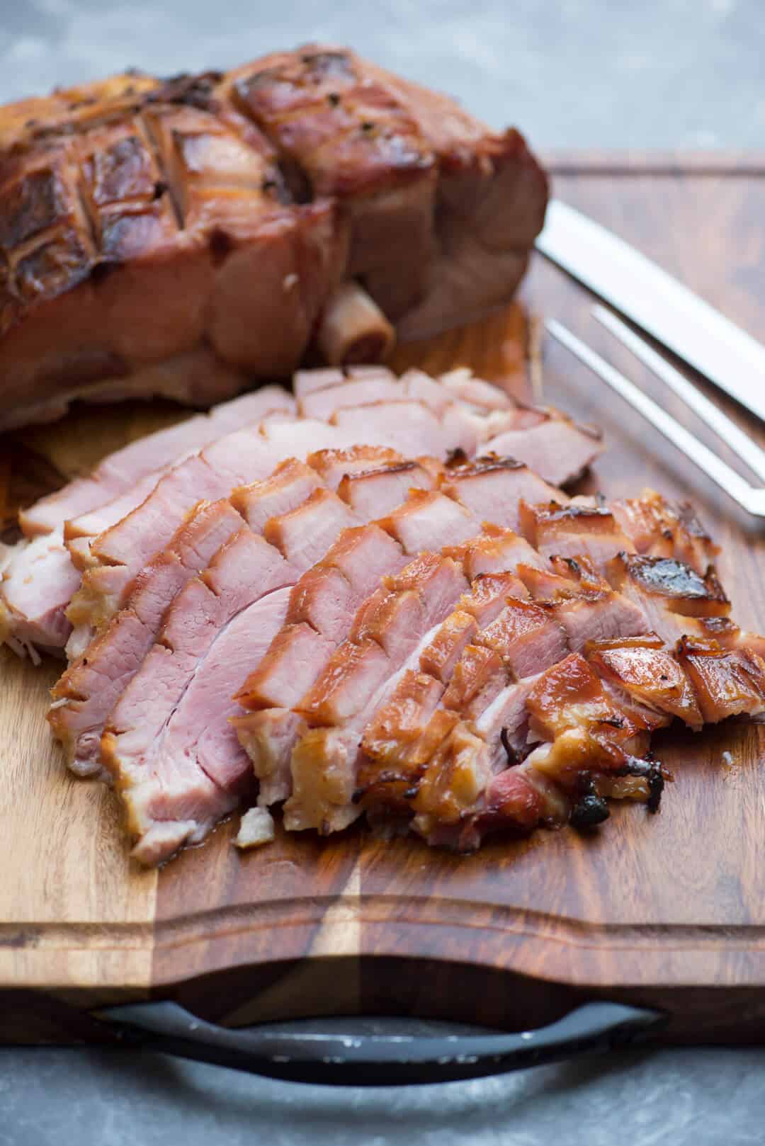 The sliced ham on a cutting board.