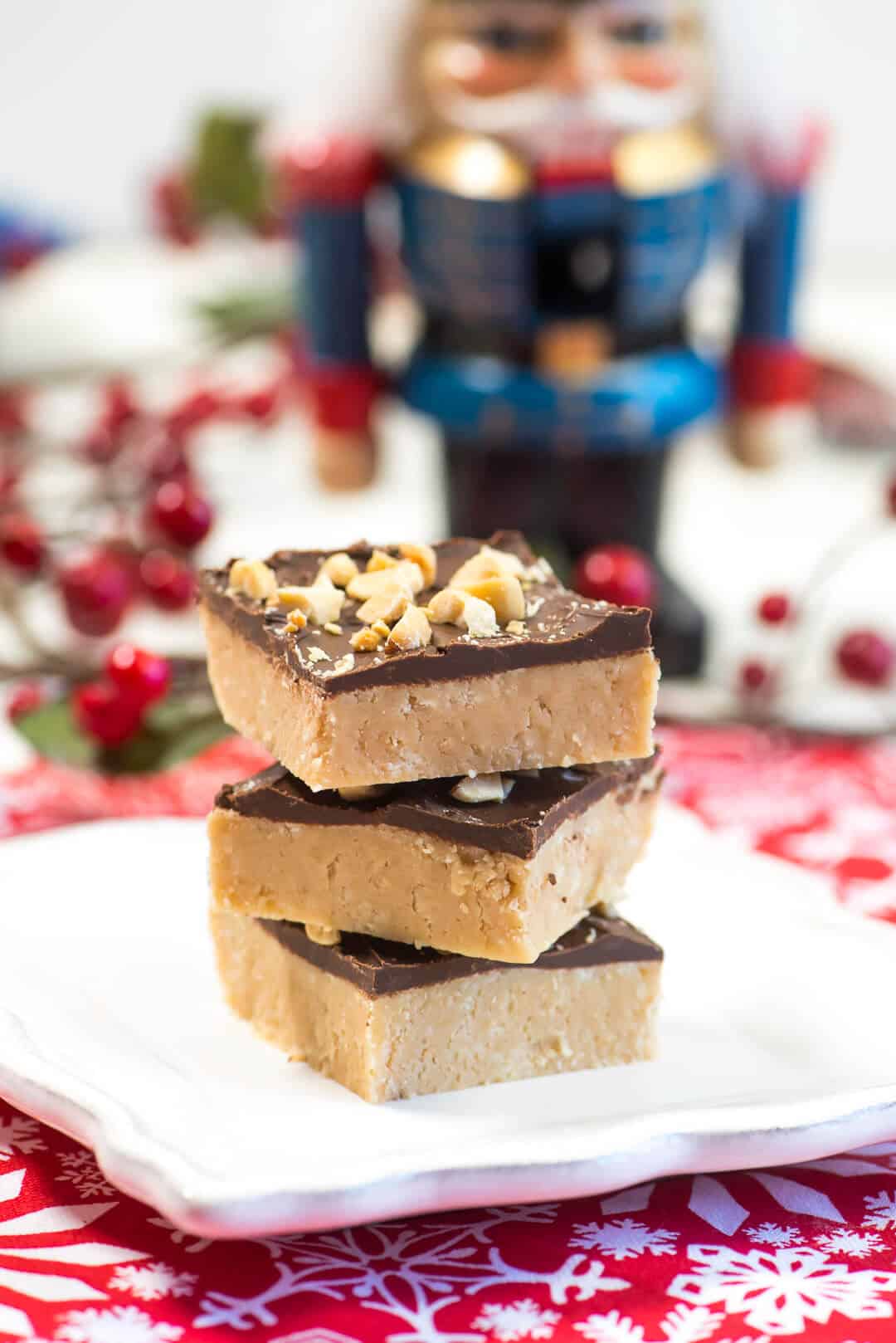 Pieces of peanut butter fudge stacked on a plate.