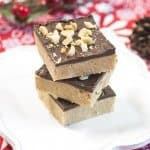 Three pieces of fudge stacked on a white plate.