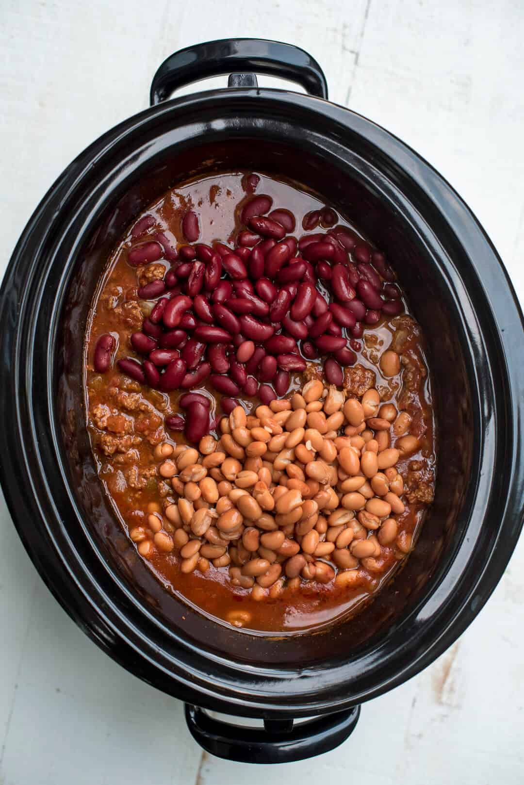 The beans are added to the slow cooker.