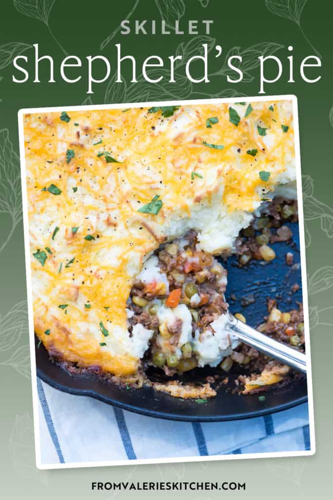 A spoon resting in a cast iron skillet filled with shepherd's pie with text overlay.