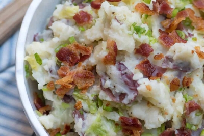 A close up of Colcannon Potatoes topped with bacon and green onions.