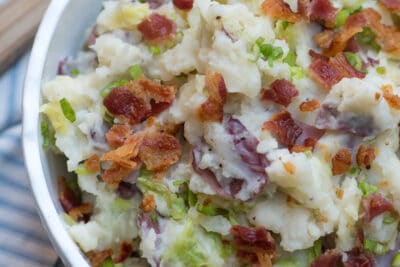 A close up of Colcannon Potatoes topped with bacon and green onions.