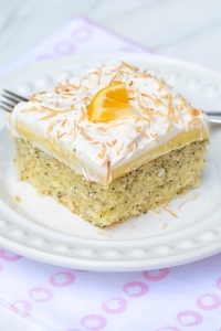 A piece of Lemon Coconut Poppy Seed Cake on a white plate.