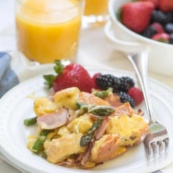 A plate with a serving of french toast bake and fruit.