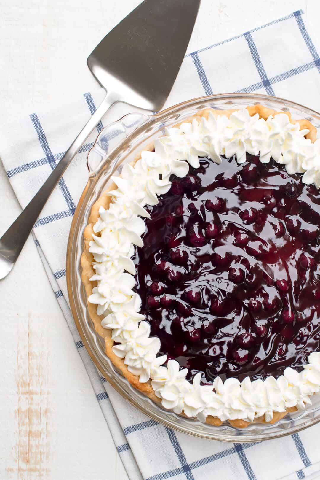 An over the top image of the pie in the pie dish with a spatula behind it.