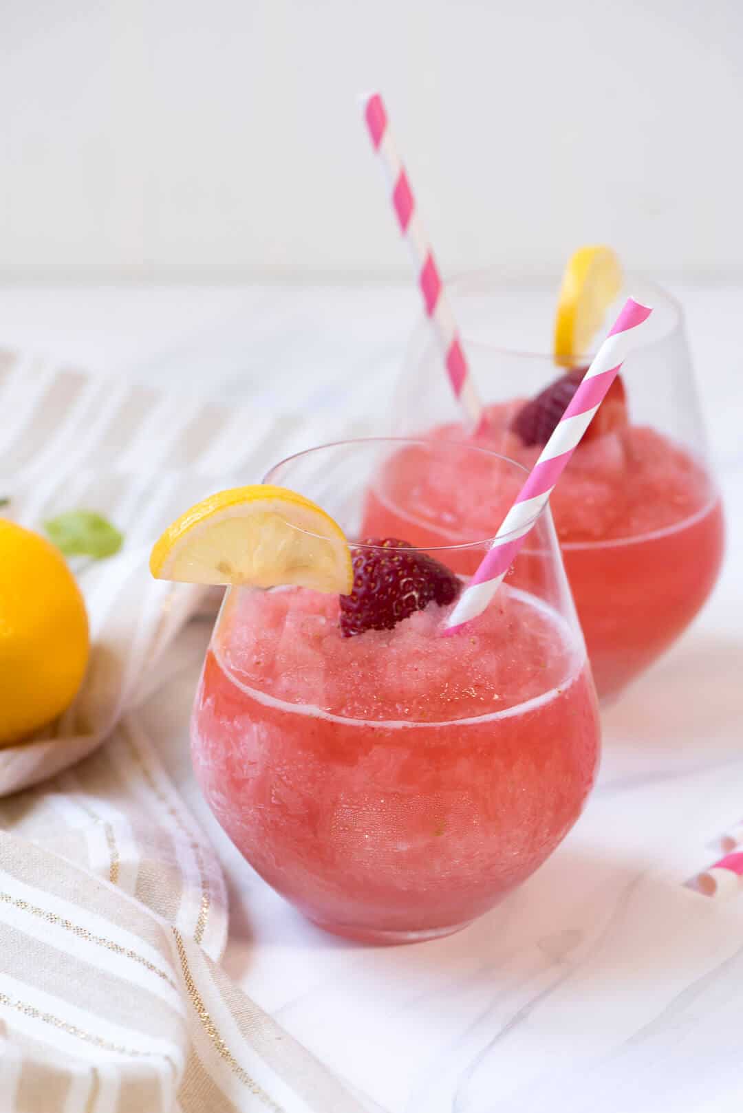 Two glasses filled with Strawberry Lemonade Frose.