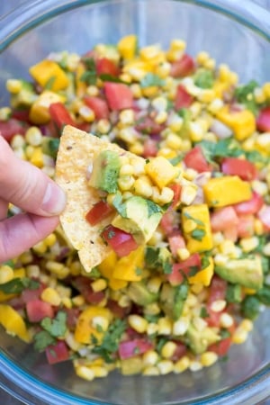 Mango Avocado Corn Salsa on a tortilla chip.