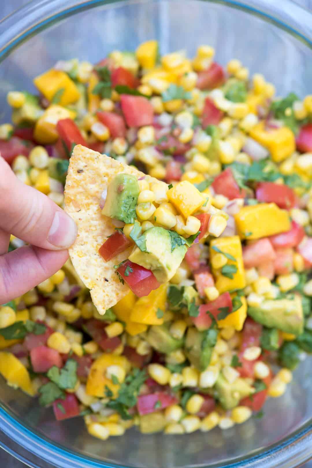 Mango Avocado Corn Salsa on a tortilla chip.